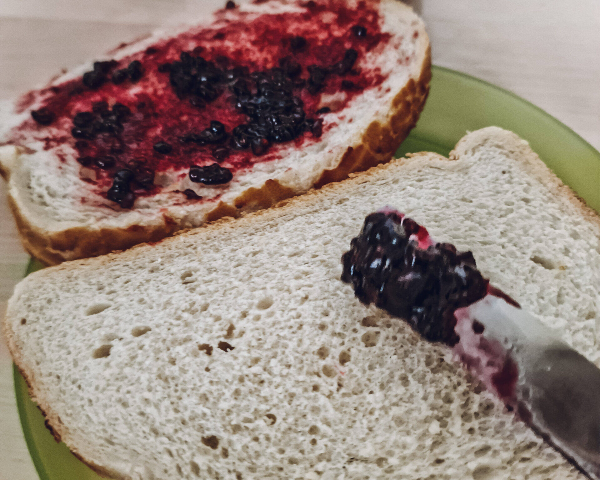 2 slices of bread with blackberry jam.